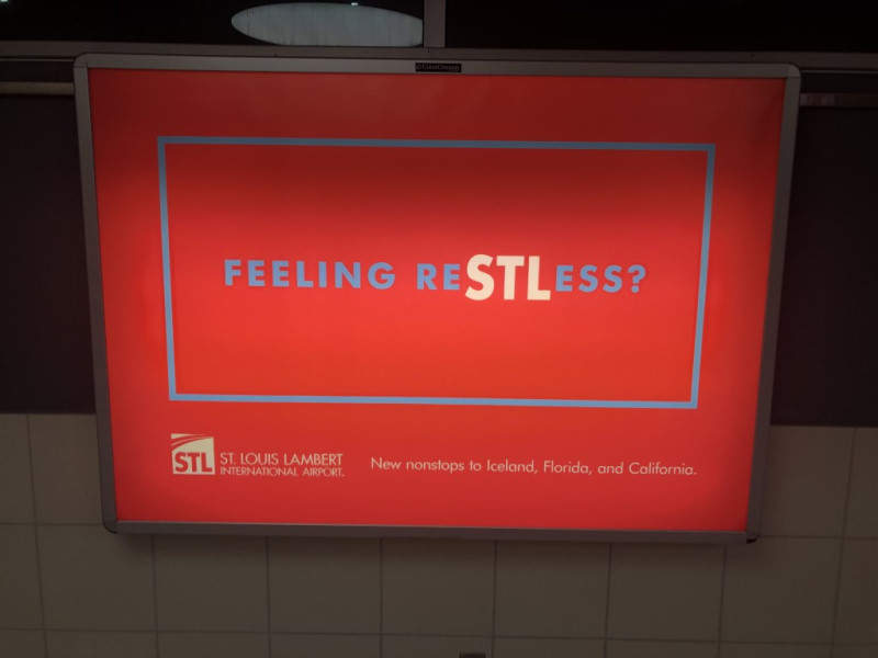 An airport sign, advertising direct flights from STL to Iceland, Florida, and California.
