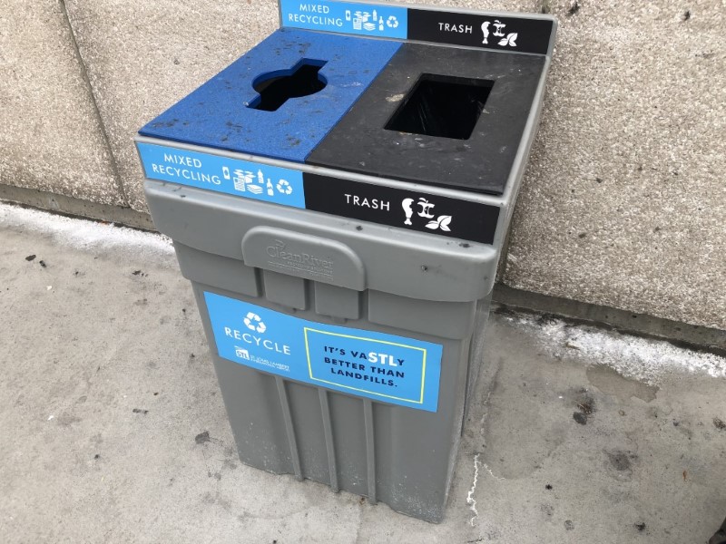 Sign on an airport recycling bin.