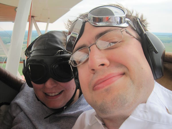 Paul and Amy riding in a biplane