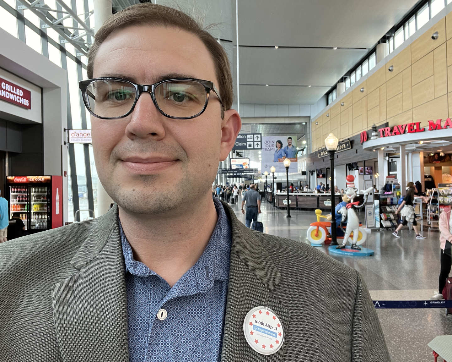 Paul at the Hartford Bradley (BDL) airport, wearing a badge reading: 100th Airport