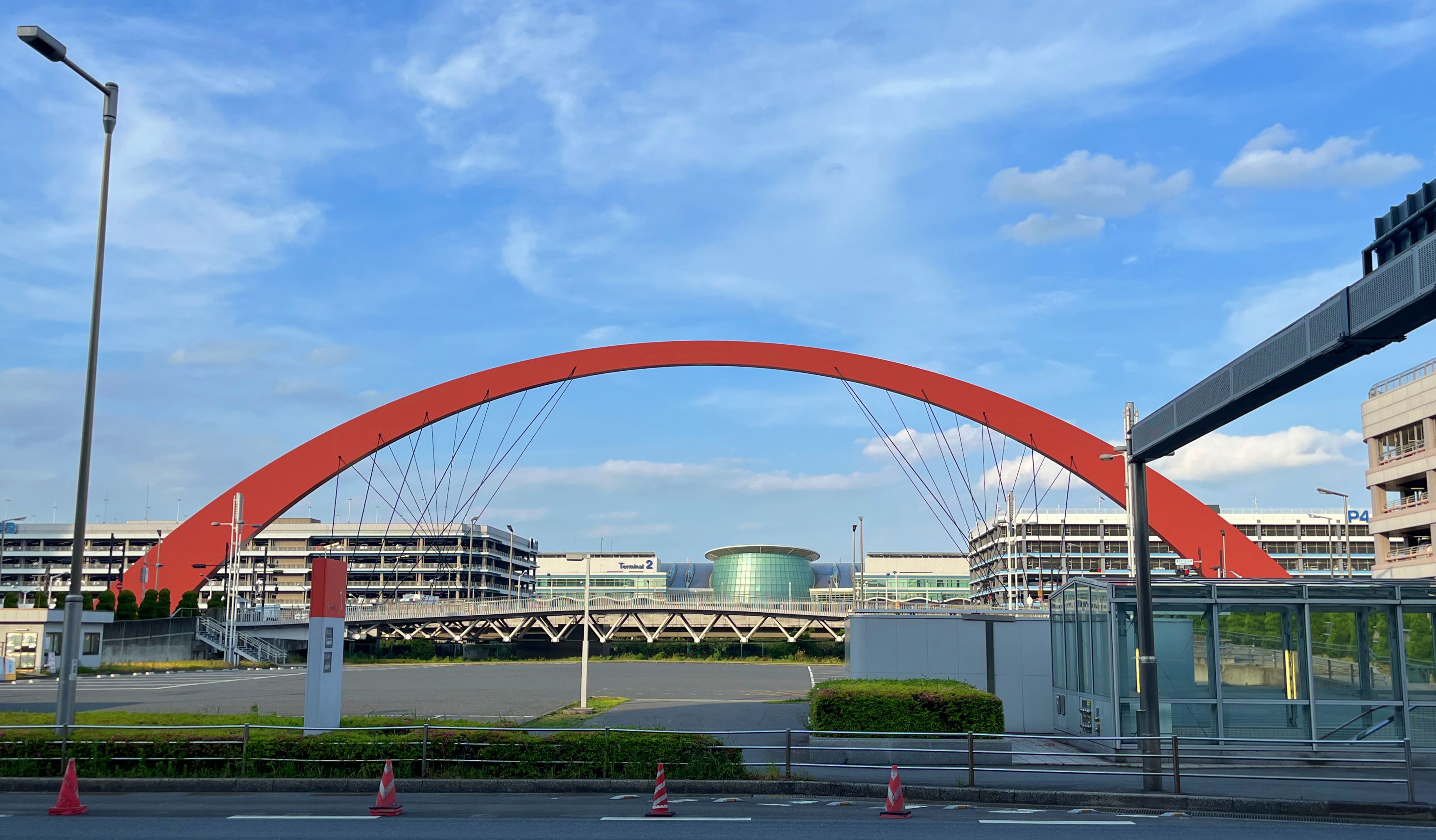 A large red arch between Terminals 1 and 2 at HND.