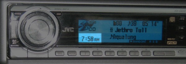 My car radio with the clock at 7:58 AM.