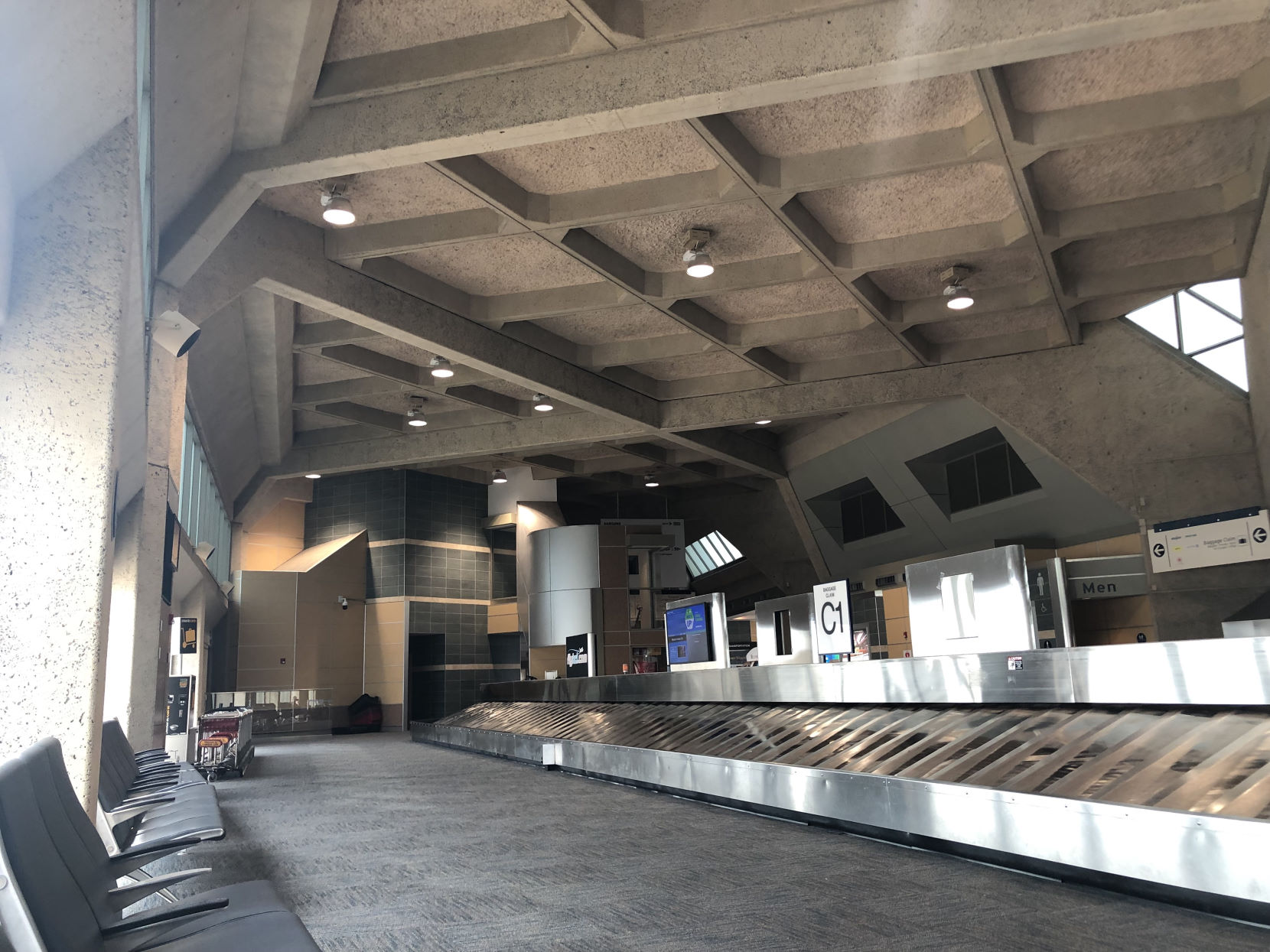 Interior roof in Terminal C. Large crossing beams create an almost-square grid at that remains at a 45-degree angle from the terminal walls as it follows the curvature of the terminal.