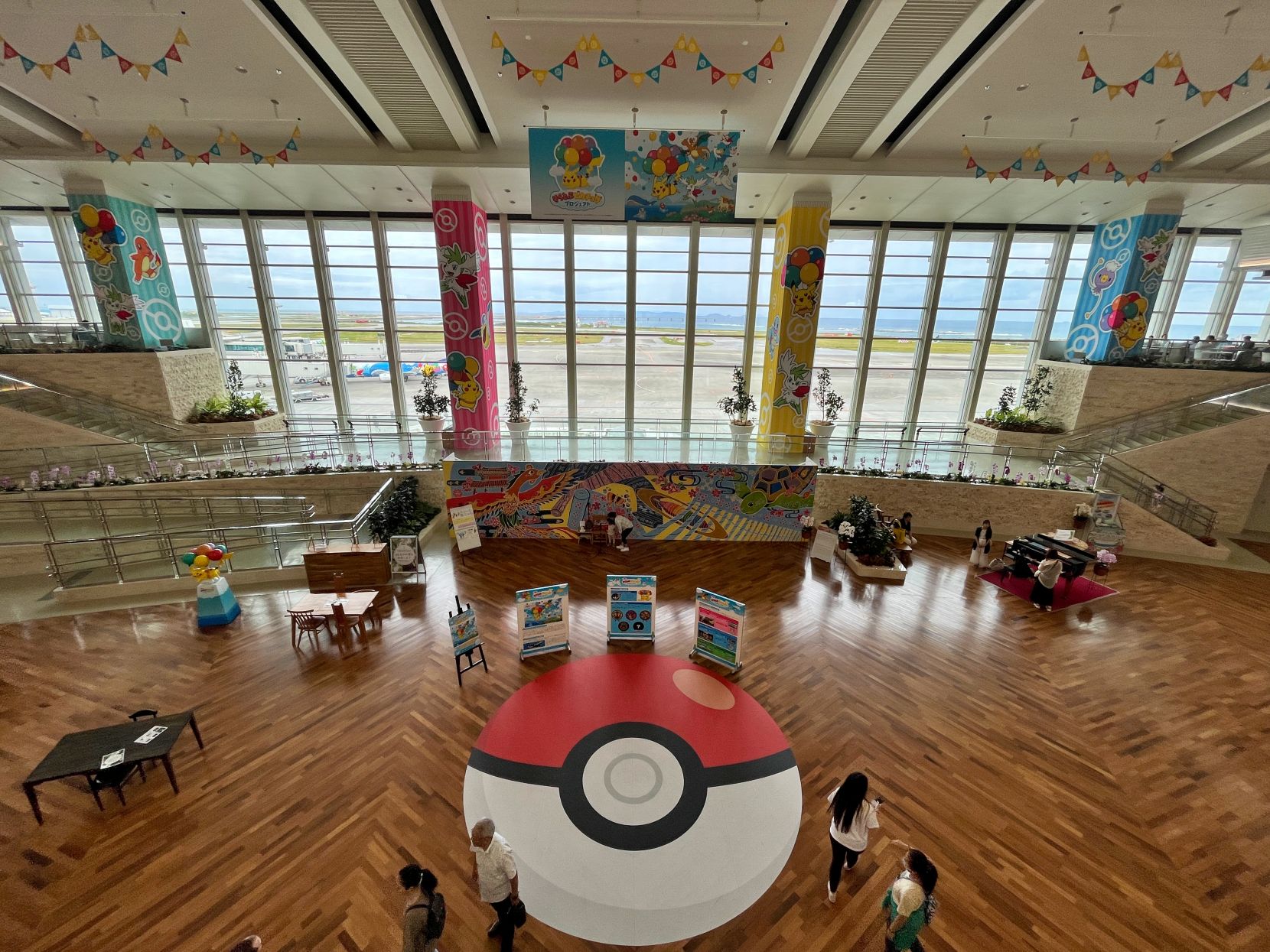 Two-story atrium heavily decorated with Pokémon.