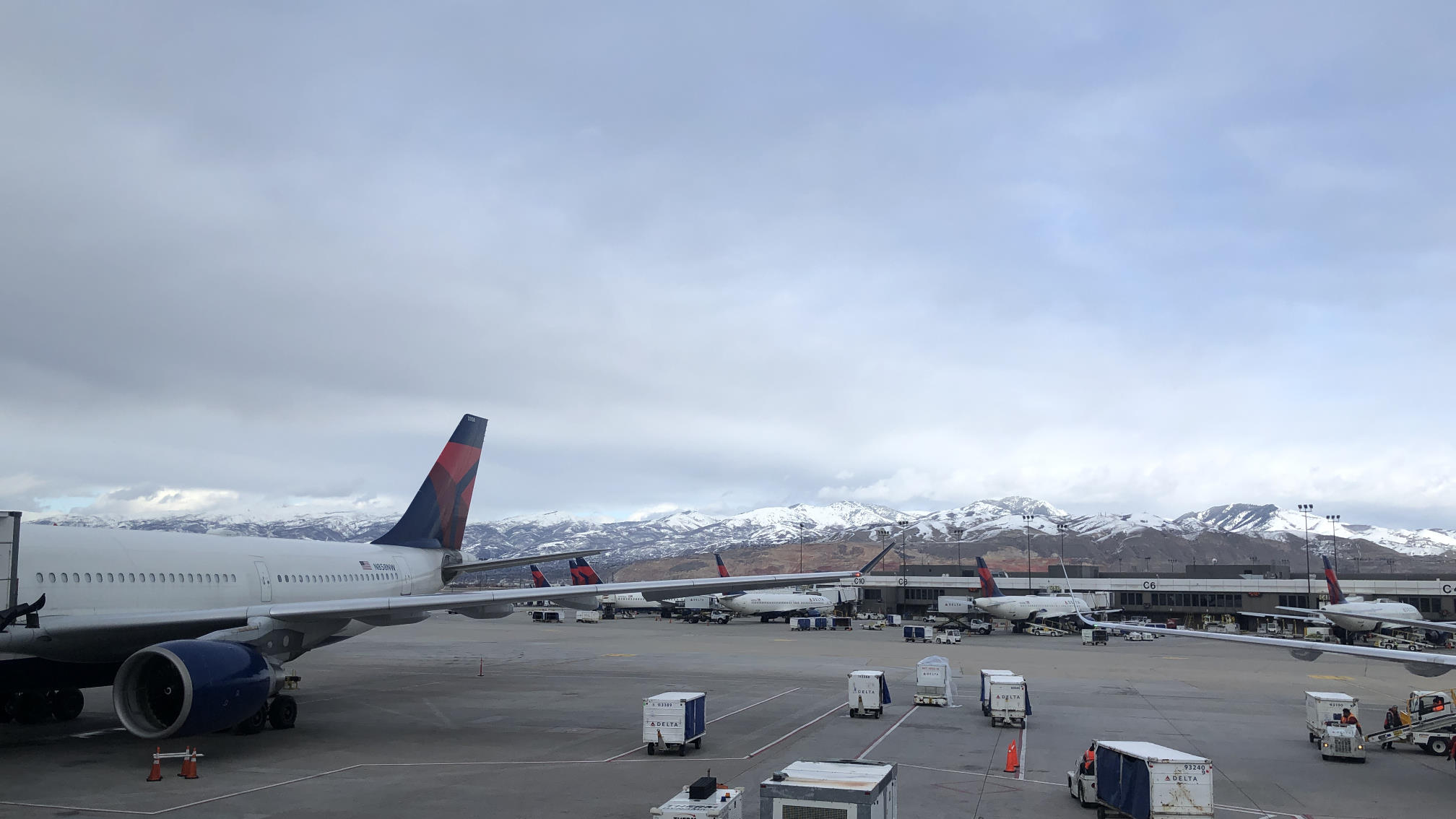 Delta jets and SLC terminals with snow-covered mountains in the distance.