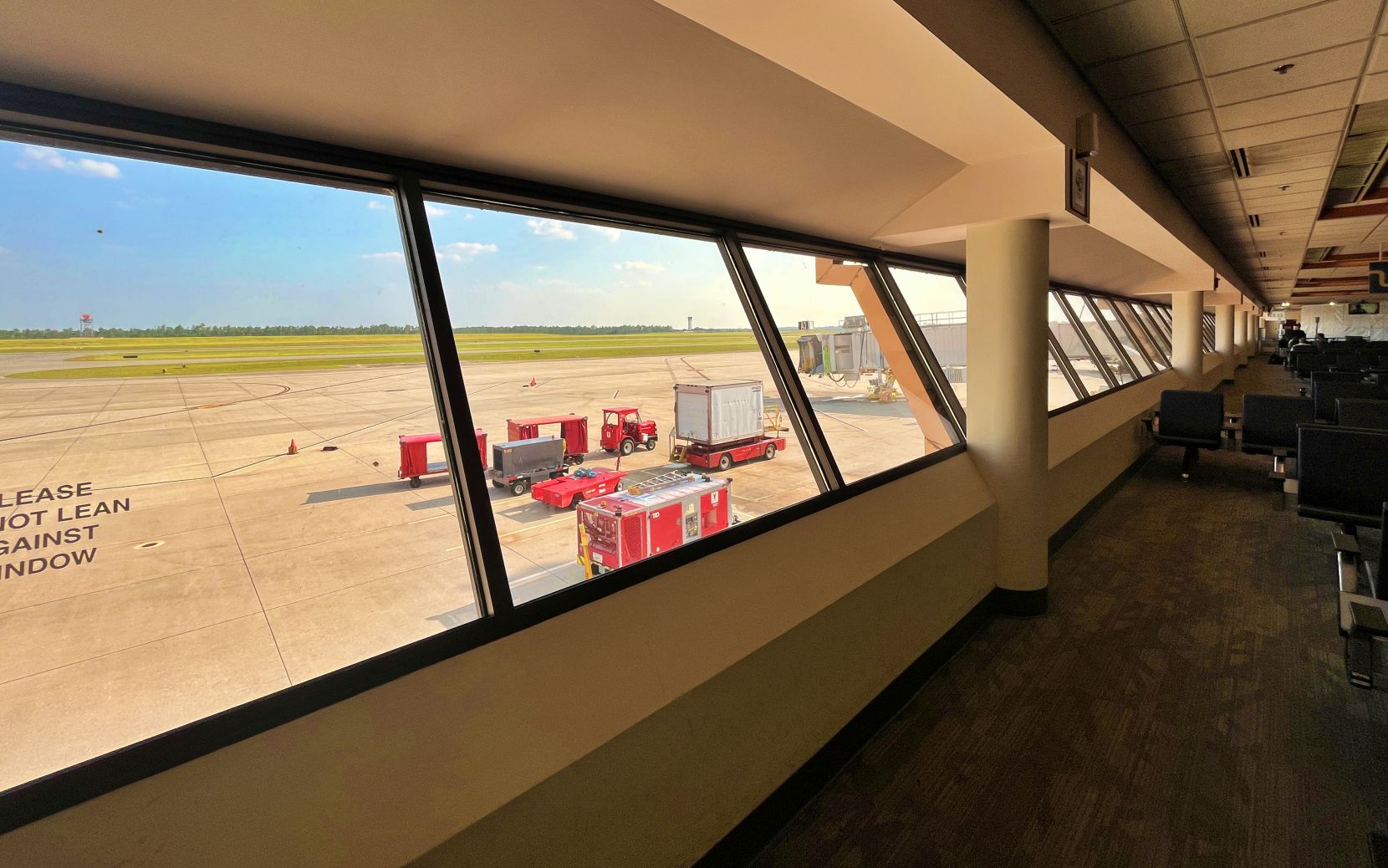 Airside terminal, with windows sloped at an angle so the window tops are further from the terminal than the bottoms.