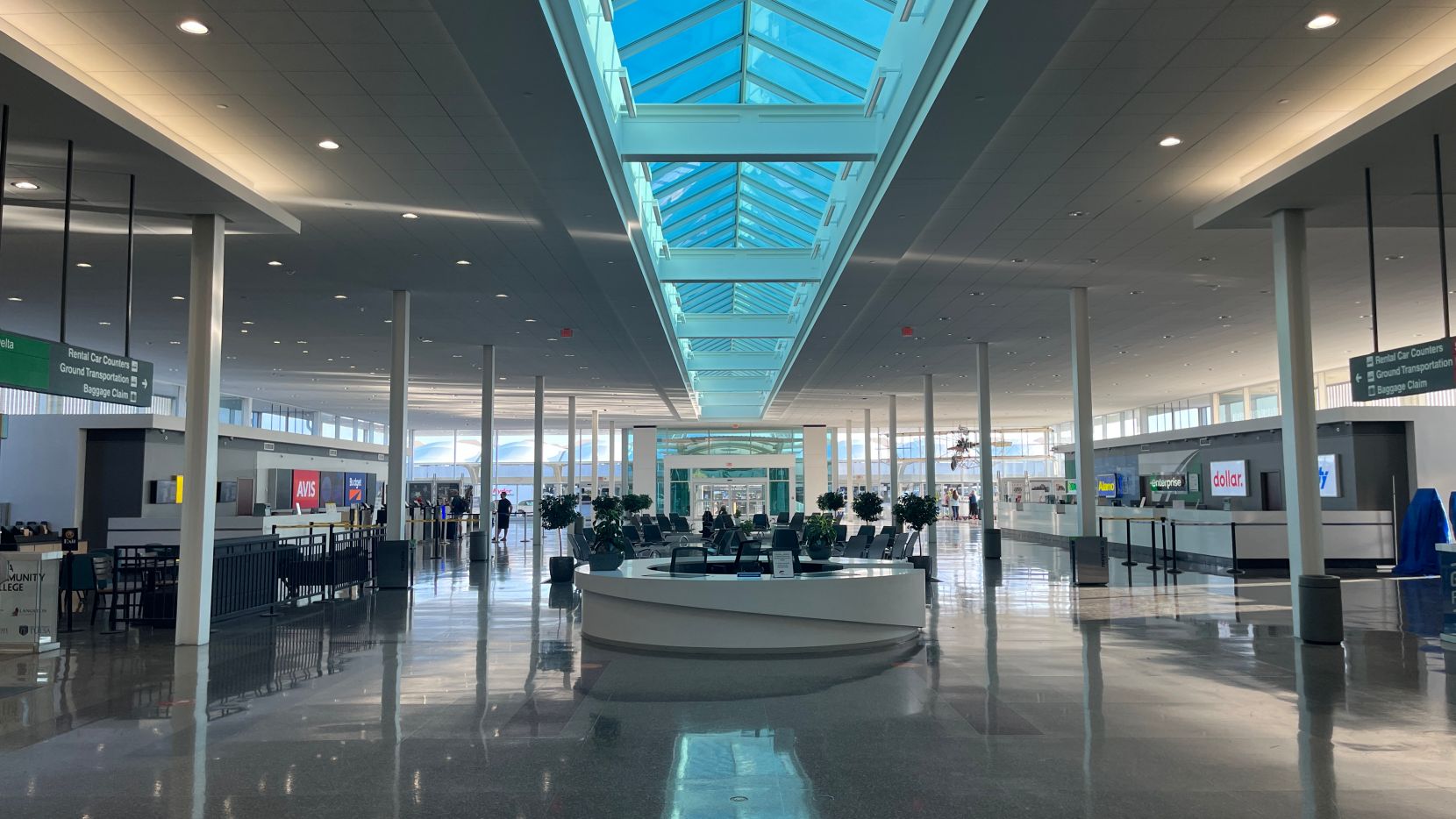 Rental car lobby with high ceiling and skylights.