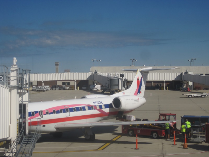 The plane with tail number N691AE parked at an airport gate.