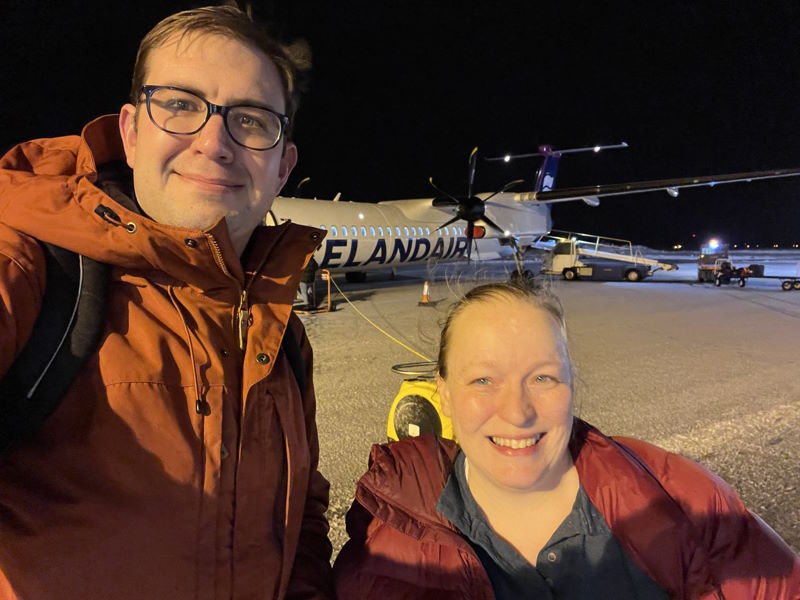 Paul and Amy in front of an Icelandair turboprop on a snowy airfield