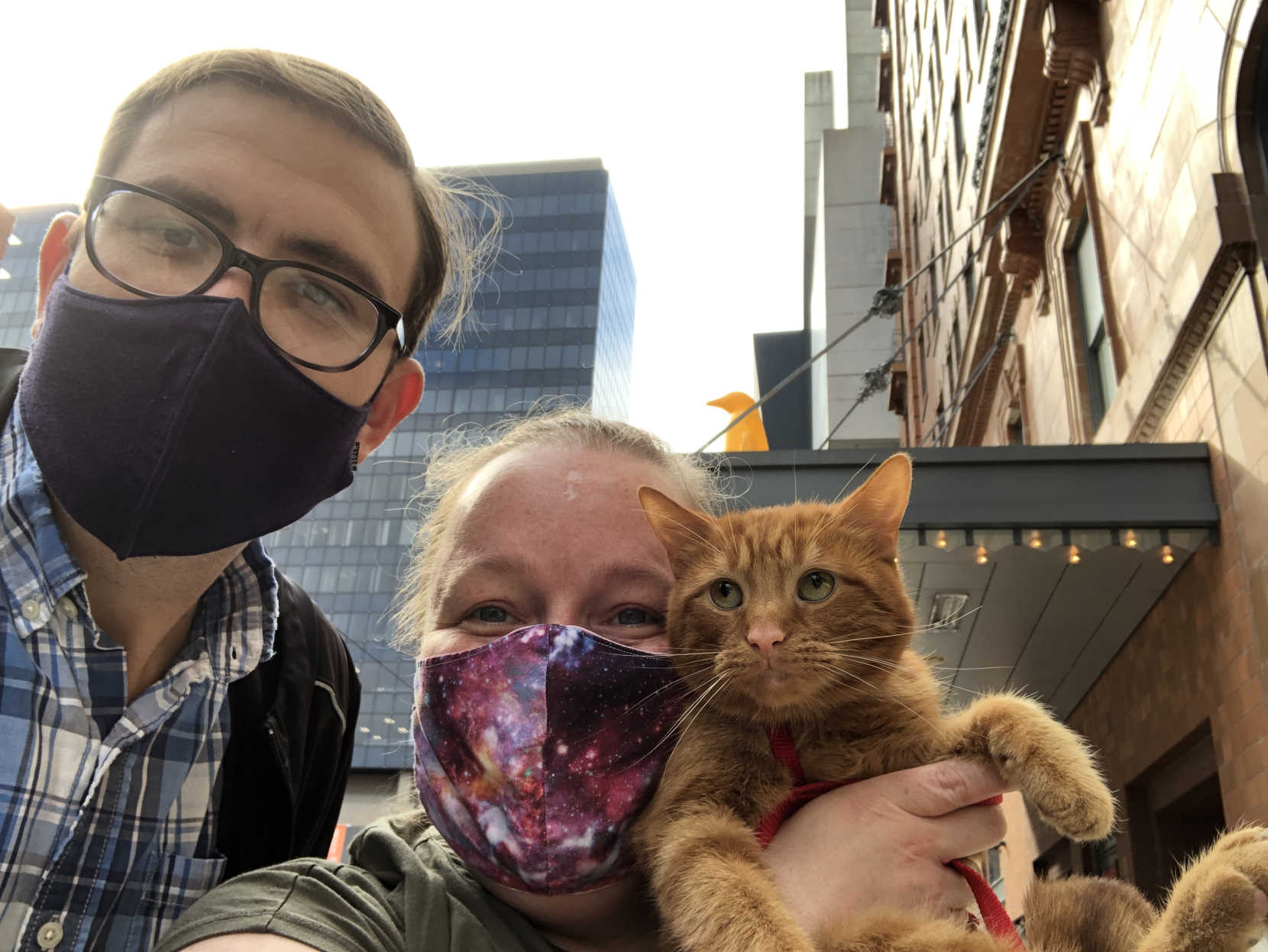 Paul, Amy, and Maxwell the cat in front of the 21c Hotel Cincinnati.
