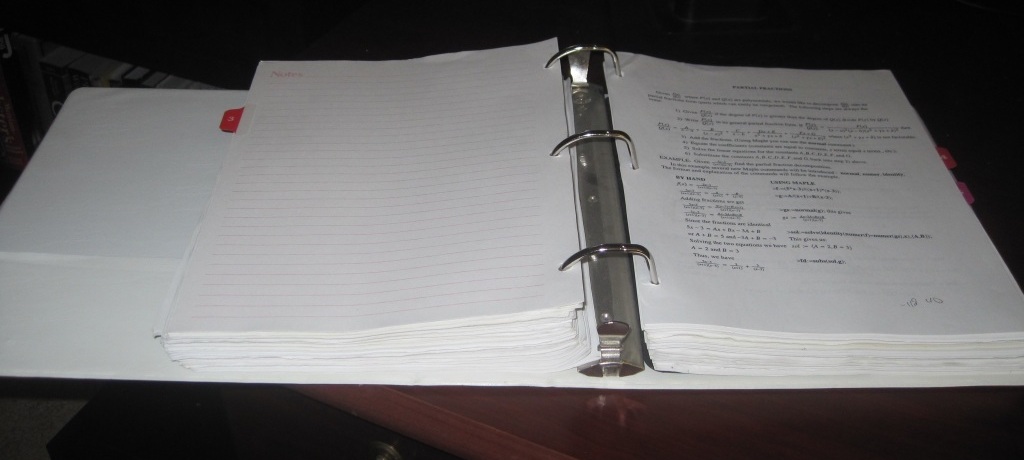 A 3-inch binder filled with homework assignments.
