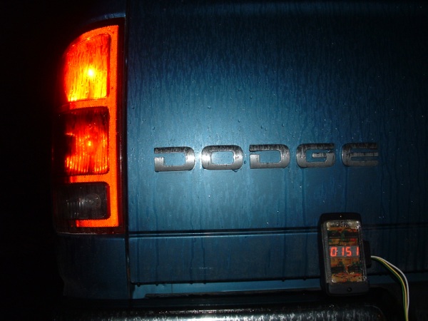 A four-digit numeric display in a waterproof case sitting on the back bumper of a pickup truck.